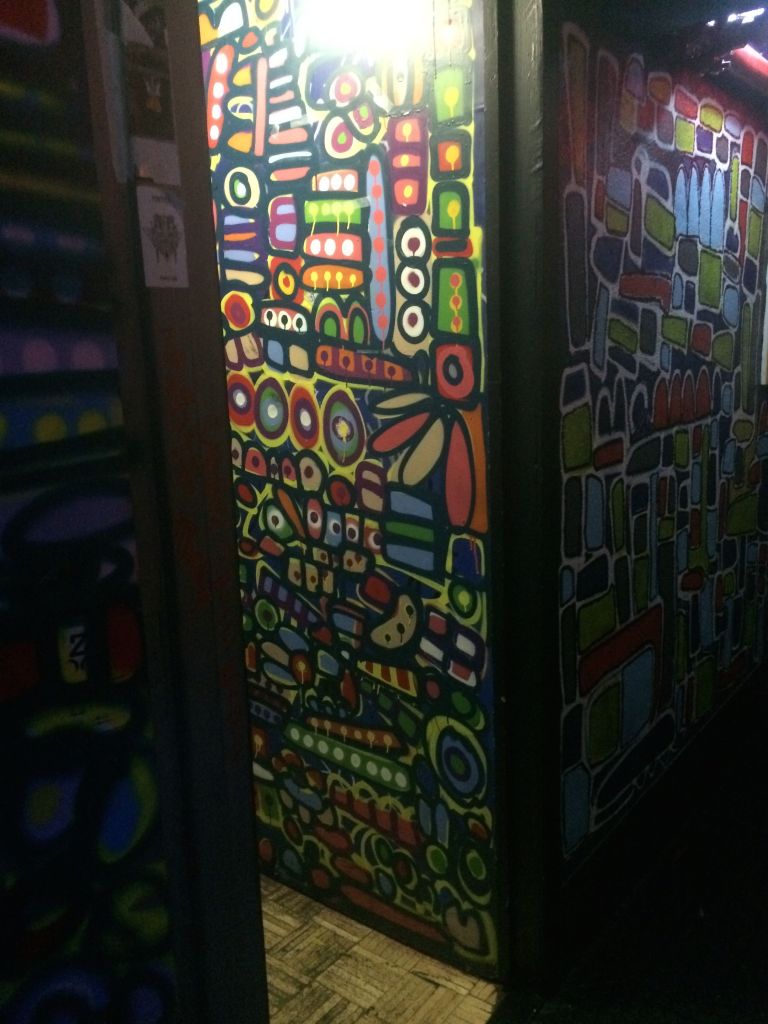 the colorful entrance to the pee stalls, at Arlene's Grocery 
